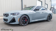 Side view of BMW M240i with low-profile splash guards