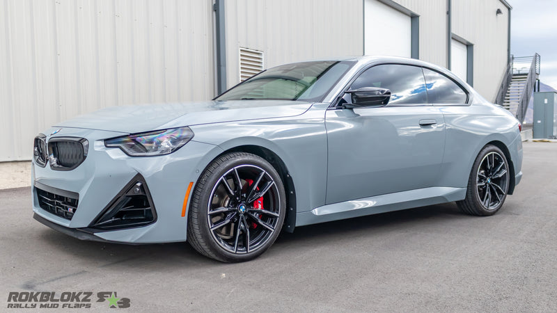 Side view of BMW M240i with low-profile splash guards